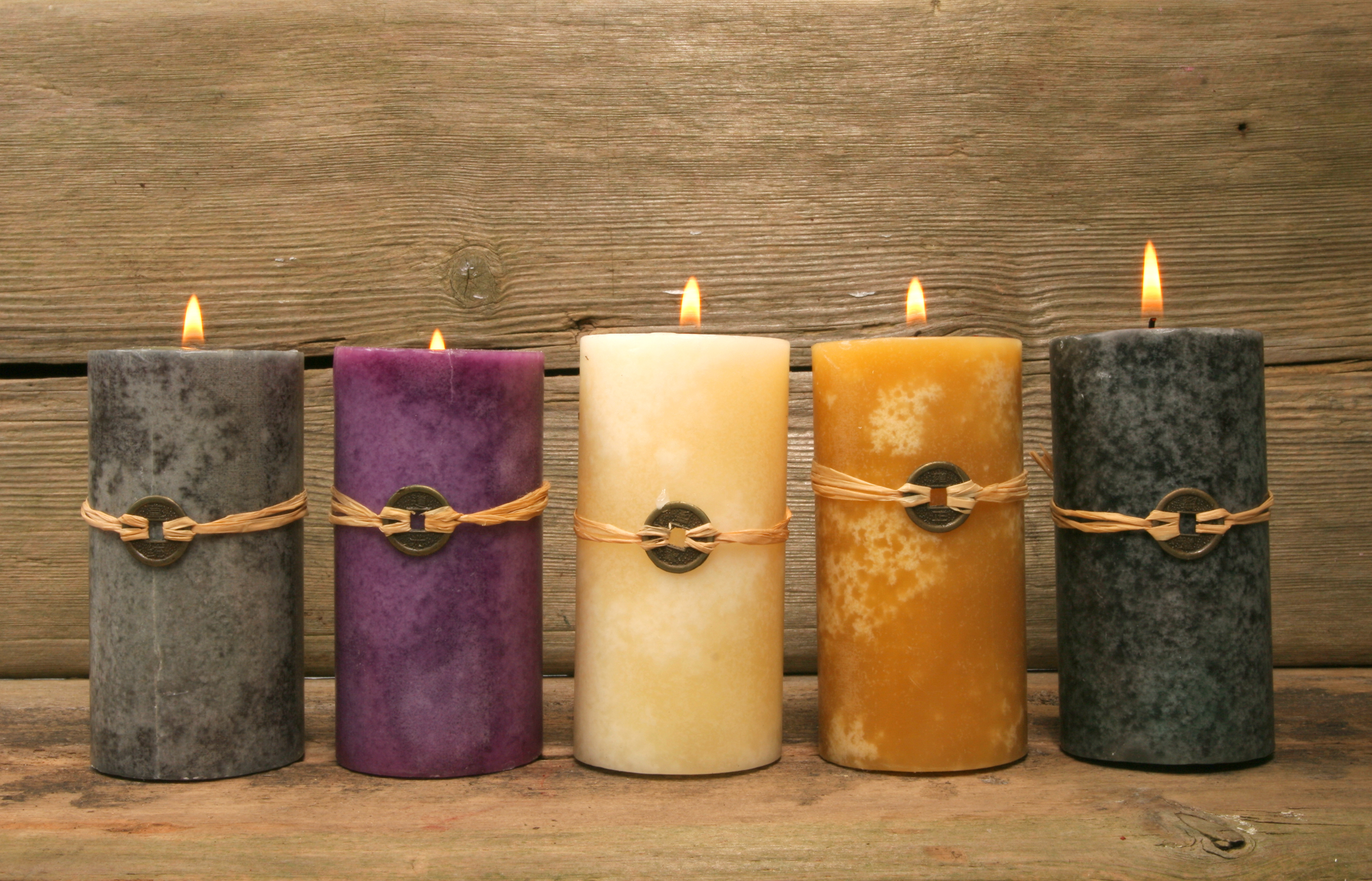 Five candles against wood background