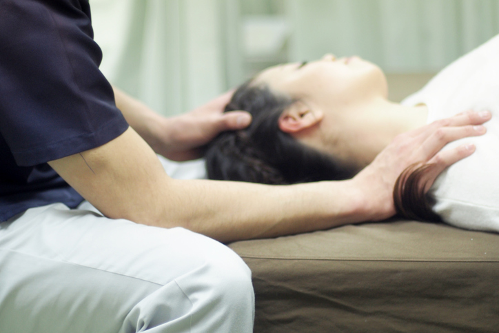 Woman receiving Jin Shin Do acupressure massage on shoulder